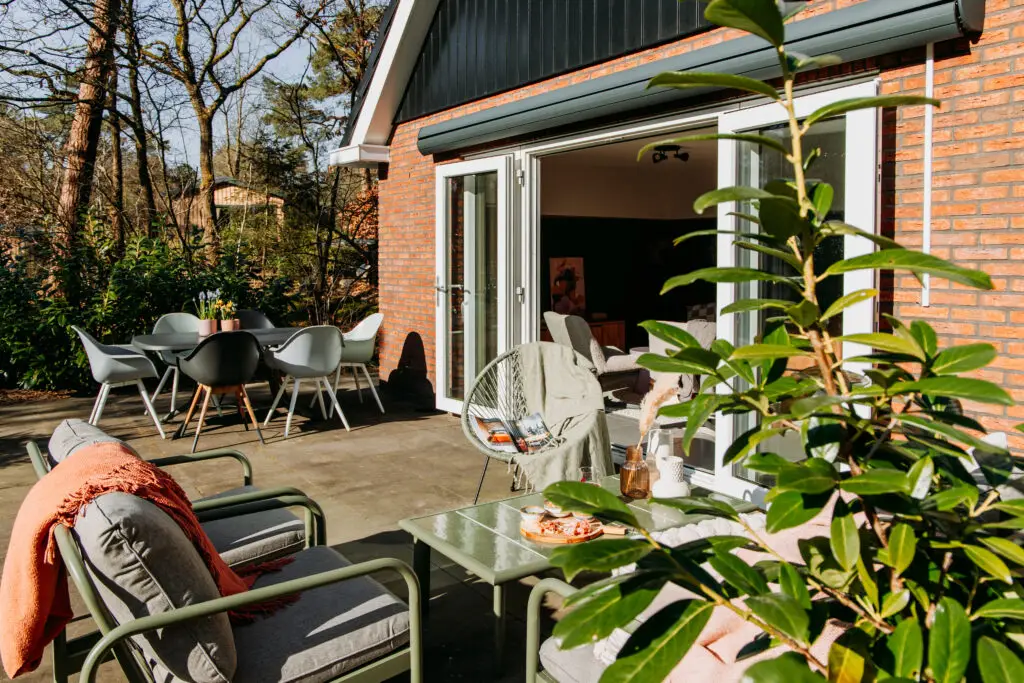 tuin met loungeset en tuintafel bij vakantiehuis Vosje op de Veluwe